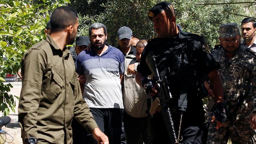 Members of Palestinian security forces loyal to Hamas escort an alleged collaborator with Israel, who was convicted in participating in killing senior Hamas commander Mazen Fuqaha, as he arrives to a Hamas-run military court in Gaza City May 21, 2017. REUTERS/Mohammed Salem  TPX IMAGES OF THE DAY - RTX36SW9