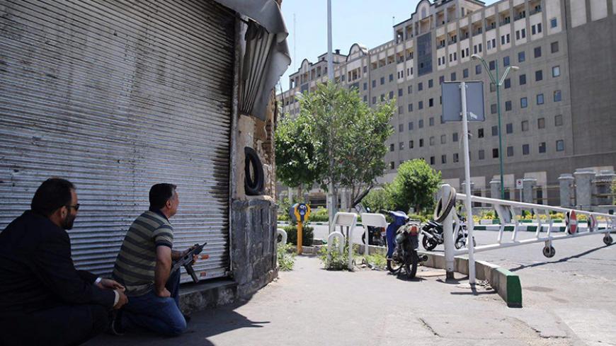Members of Iranian forces take position during an attack on the Iranian parliament in central Tehran, Iran, June 7, 2017. Omid Vahabzadeh/TIMA via REUTERS ATTENTION EDITORS - THIS IMAGE WAS PROVIDED BY A THIRD PARTY. FOR EDITORIAL USE ONLY. - RTX39EMR