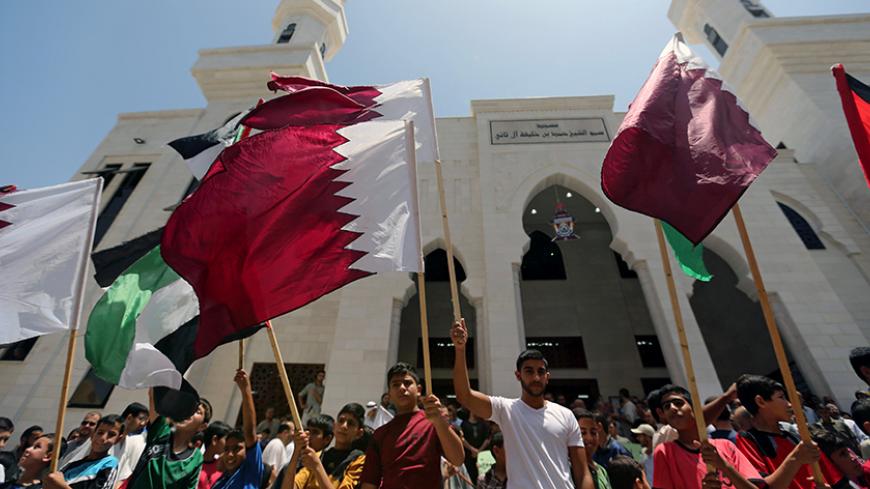 Palestinians take part in a rally in support of Qatar, inside Qatari-funded construction project 'Hamad City', in the southern Gaza Strip, June 9, 2017. REUTERS/Ibraheem Abu Mustafa - RTX39TF1