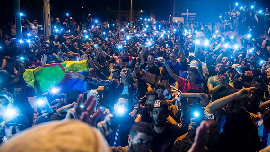 Protesters from Rif movement Al-Hirak Al-Shaabi, or "Popular Movement" chant during a demonstration against corruption, repression and unemployment in Morocco's northern town of Imzouren in the early hours of June 11, 2017. 
Demonstrators have rallied nightly in Al-Hoceima and the nearby town of Imzouren since the arrest of Al-Hirak leader Nasser Zefzafi on May 29 and the subsequent arrests of dozens more. / AFP PHOTO / FADEL SENNA        (Photo credit should read FADEL SENNA/AFP/Getty Images)