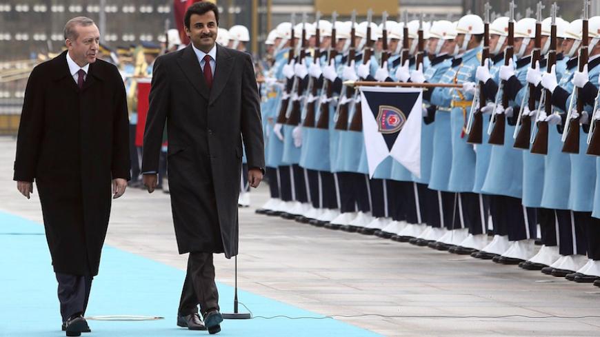 Qatari Crown Prince Sheikh Tamim bin Hamad bin Khalifa al-Thani (2ndL) and Turkish President Recep Tayyip Erdogan (L), walk past a guard of honor during an official welcoming ceremony prior to their meeting at the presidential palace in Ankara, Turkey, on December 19, 2014. AFP PHOTO / ADEM ALTAN        (Photo credit should read ADEM ALTAN/AFP/Getty Images)