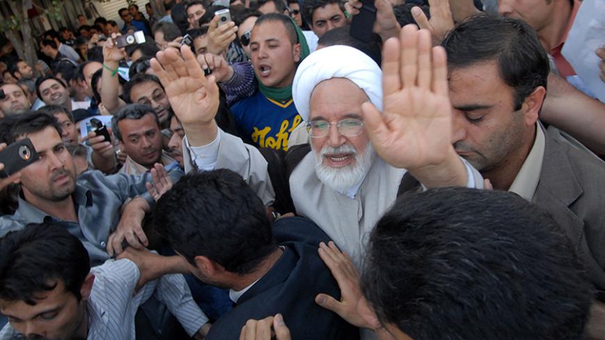 EDITORS' NOTE: Reuters and other foreign media are subject to Iranian restrictions on leaving the office to report, film or take pictures in Tehran.

Iran's presidential candidate Mehdi Karroubi (3rd R) joins a crowd of supporters in Tehran June 17, 2009. REUTERS/Demotix (IRAN POLITICS ELECTIONS CONFLICT) - RTR24RIO
