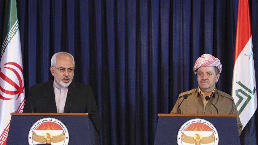Iranian foreign minister Mohammad Javad Zarif (L) speaks during a news conference with Iraqi Kurdish regional President Masoud Barzani  in Arbil, north of Baghdad, August 26, 2014. Iran supplied weapons and ammunition to Iraqi Kurdish forces, Barzani said Tuesday at a joint news conference with Zarif in Arbil, capital of Iraq's autonomous Kurdish region.  REUTERS/Azad Lashkari (IRAQ - Tags: POLITICS TPX IMAGES OF THE DAY CONFLICT CIVIL UNREST) - RTR43T95