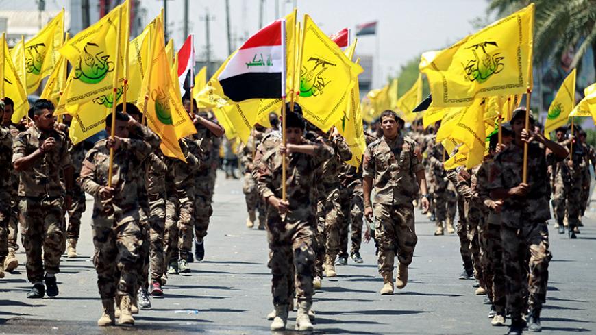 Iraqi Shi'ite Muslims from Hashid Shaabi (Popular Mobilization) march during a parade marking the annual al-Quds Day, or Jerusalem Day, in Baghdad, Iraq June 23, 2017. REUTERS/Khalid al Mousily - RTS18BPH