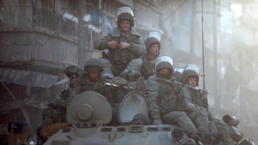 Russian soldiers, on armoured vehicles, patrol a street in Aleppo, Syria February 2, 2017. Picture taken February 2, 2017. REUTERS/Omar Sanadiki - RTX30GQ1