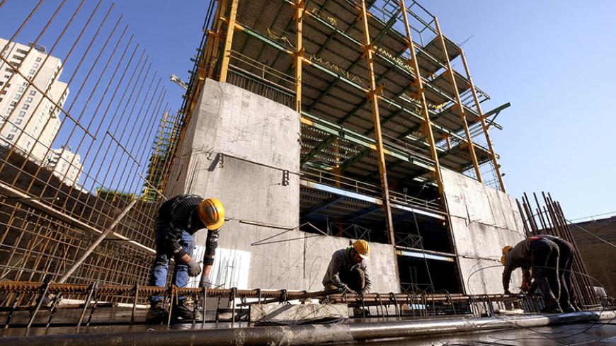 FILE PHOTO: Labourers work at the construction site of a building in Tehran, Iran January 20, 2016.  REUTERS/Raheb Homavandi/TIMA/File Photo  ATTENTION EDITORS - THIS IMAGE WAS PROVIDED BY A THIRD PARTY. FOR EDITORIAL USE ONLY. - RTX38OJS