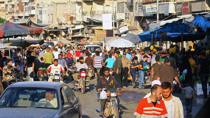 People shop during the holy month of Ramadan in the rebel-held Idlib city, Syria June 8, 2017. Picture taken June 8, 2017. REUTERS/Ammar Abdullah - RTX39SDA