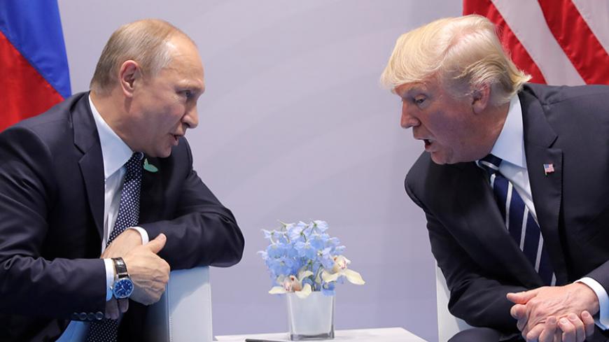 U.S. President Donald Trump speaks with Russian President Vladimir Putin during the their bilateral meeting at the G20 summit in Hamburg, Germany July 7, 2017. REUTERS/Carlos Barria     TPX IMAGES OF THE DAY - RTX3AI4I
