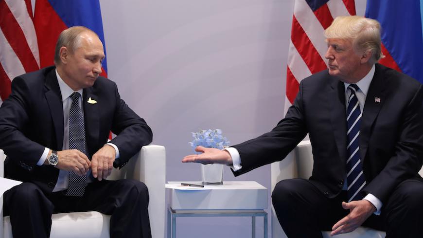 U.S. President Donald Trump meets with Russian President Vladimir Putin during the their bilateral meeting at the G20 summit in Hamburg, Germany July 7, 2017. REUTERS/Carlos Barria - RTX3AI59