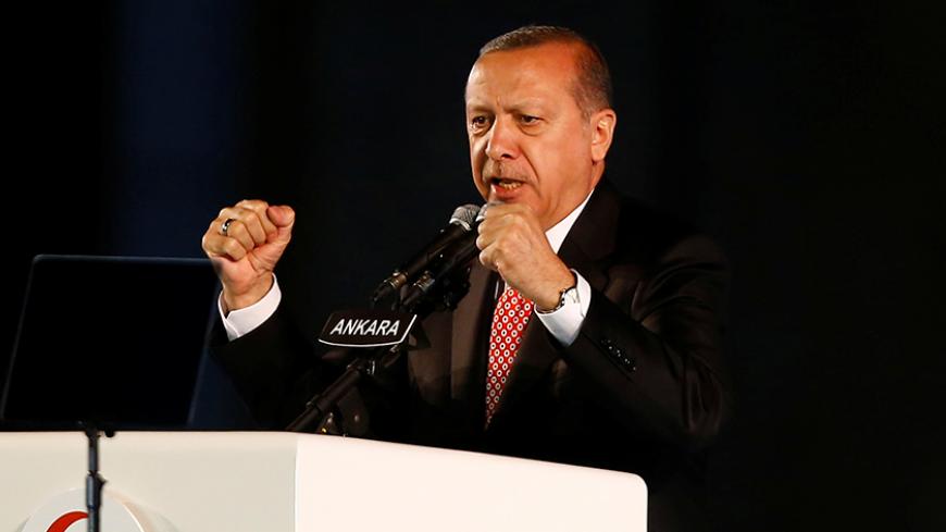 Turkey's President Tayyip Erdogan addresses his supporters during a ceremony marking the first anniversary of the attempted coup in front of the Turkish Parliament in Ankara, Turkey July 16, 2017. REUTERS/Umit Bektas - RTX3BN1M