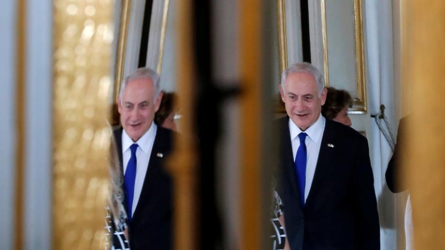 Israeli Prime Minister Benjamin Netanyahu is reflected in a mirror as he attends a joint declaration with French President Emmanuel Macron at the Elysee Palace in Paris, France, July 16, 2017.  REUTERS/Stephane Mahe/Pool - RTX3BO2K