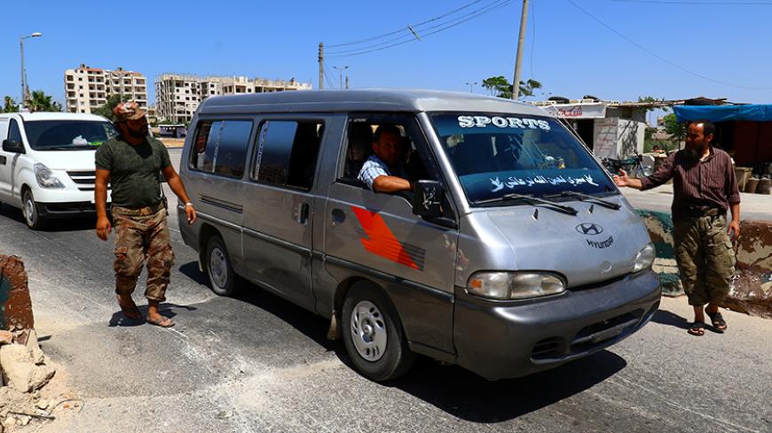 Members from a coalition of rebel groups called "Jaish al Fateh", also known as "Army of Fatah" (Conquest Army), man a checkpoint in Idlib city, Syria July 18, 2017. Picture taken July 18, 2017. REUTERS/Ammar Abdullah - RTX3C9L8