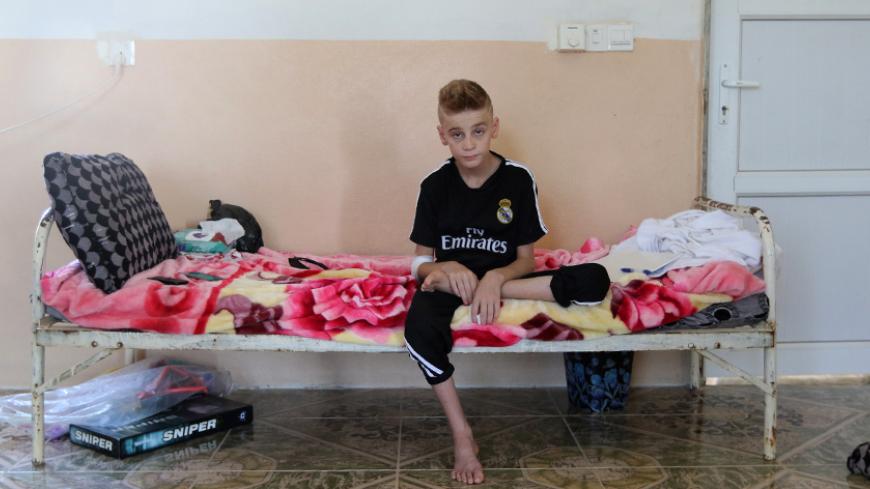 A Yazidi boy, twelve year-old Imad Tammo rescued from Islamic State militants by the Iraqi army, is seen in Sina neighbourhood outside of Duhok, Iraq July 25, 2017. REUTERS/Ari Jalal - RTX3CVCQ