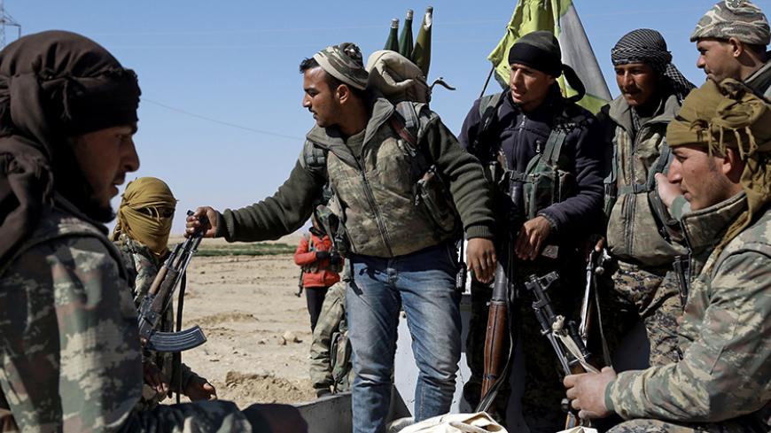 US-backed Syrian Democratic Forces (SDF), made up of an alliance of Arab and Kurdish fighters, regroup in the village of Sabah al-Khayr on the northern outskirts of Deir Ezzor as they advance to encircle the Islamic State (IS) group bastion of Raqa on February 21, 2017.
The SDF made a major incursion into the oil-rich province of Deir Ezzor as part of their push for Raqa, field commander Dejwar Khabat said. 



 / AFP / DELIL SOULEIMAN        (Photo credit should read DELIL SOULEIMAN/AFP/Getty Images)
