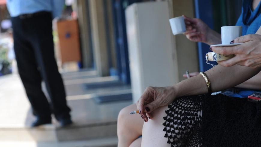 Turkish women smoke cigarettes outside a teahouse in Istanbul on July 19, 2009. On July 19, cigarettes have been totally banned in bars, restaurants and other recreational places in Turkey. AFP PHOTO/BULENT KILIC        (Photo credit should read BULENT KILIC/AFP/GettyImages)