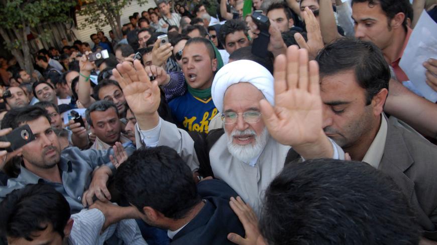 EDITORS' NOTE: Reuters and other foreign media are subject to Iranian restrictions on leaving the office to report, film or take pictures in Tehran.

Iran's presidential candidate Mehdi Karroubi (3rd R) joins a crowd of supporters in Tehran June 17, 2009. REUTERS/Demotix (IRAN POLITICS ELECTIONS CONFLICT) - RTR24RIO