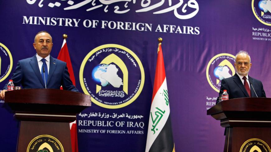Turkish foreign minister Mevlut Cavusoglu (L) speaks during a joint news conference with Iraqi Foreign Minister Ibrahim al-Jaafari in Baghdad, Iraq August 23, 2017. REUTERS/Khalid al Mousily - RTS1CY8B