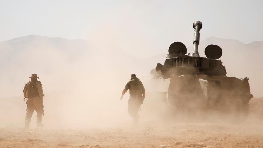 Hezbollah fighter walk near a military tank in Western Qalamoun, Syria August 23, 2017. REUTERS/Omar Sanadiki - RTS1D0E2
