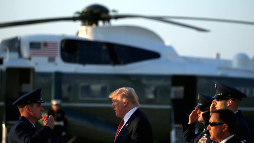 U.S. President Donald Trump is greeted by military personnel as he arrives at Joint Base Andrews, Maryland, U.S., August 23, 2017.   REUTERS/Joshua Roberts - RTS1D28A