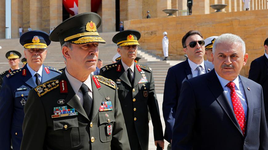 Turkey's Prime Minister Binali Yildirim (R), flanked by Chief of Staff General Hulusi Akar (L) and the country's top generals, leaves Anitkabir, the mausoleum of modern Turkey founder Mustafa Kemal Ataturk, after a wreath-laying ceremony ahead of a High Military Council meeting in Ankara, Turkey, July 28, 2016. REUTERS/Umit Bektas - RTSK1K6