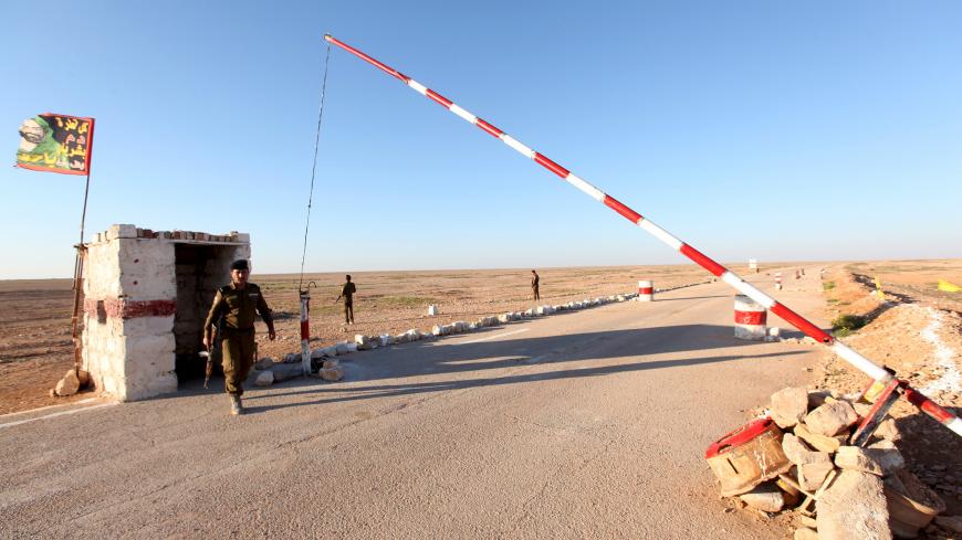 A member from the Iraqi security forces stands guard at a checkpoint during a patrol at the border between Iraq and Saudi Arabia, February 17, 2016. Picture taken February 17, 2016. REUTERS/Alaa Al-Marjani  - RTX27OUC