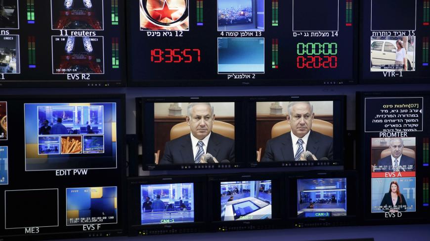 Israel's Prime Minister Benjamin Netanyahu is seen on monitors before the evening news bulletin at Channel 10's control room in Jerusalem November 18, 2015. REUTERS/Ronen Zvulun/File Photo - RTX2SI5L