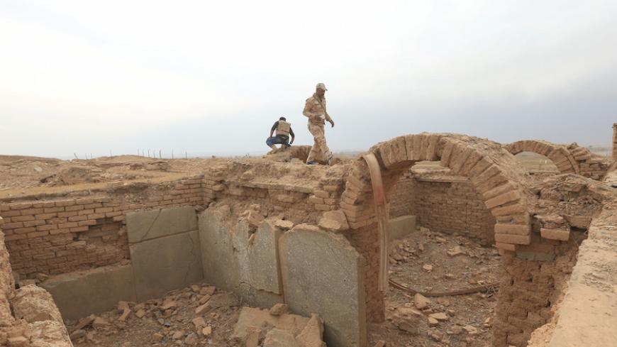 A member of Iraqi army walks at the remains of wall panels and colossal statues of winged bulls, destroyed by Islamic State militants in the Assyrian city of Nimrud eastern bank of the Tigris River, south of Mosul, Iraq, November 16, 2016. REUTERS/Ari Jalal - RTX2TYPA