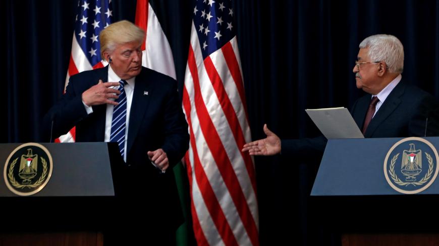 Palestinian President Mahmoud Abbas extends his hand to shake hands with U.S. President Donald Trump during a joint news conference at the presidential headquarters in the West Bank town of Bethlehem, May 23, 2017. REUTERS/Mohamad Torokman - RTX375A1