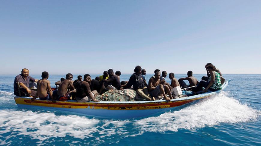 Migrants ride in a boat after they were rescued by Libyan coastguard off the coast of Gharaboli, east of Tripoli, Libya July 8, 2017. REUTERS/Ismail Zitouny      TPX IMAGES OF THE DAY - RTX3AMD9