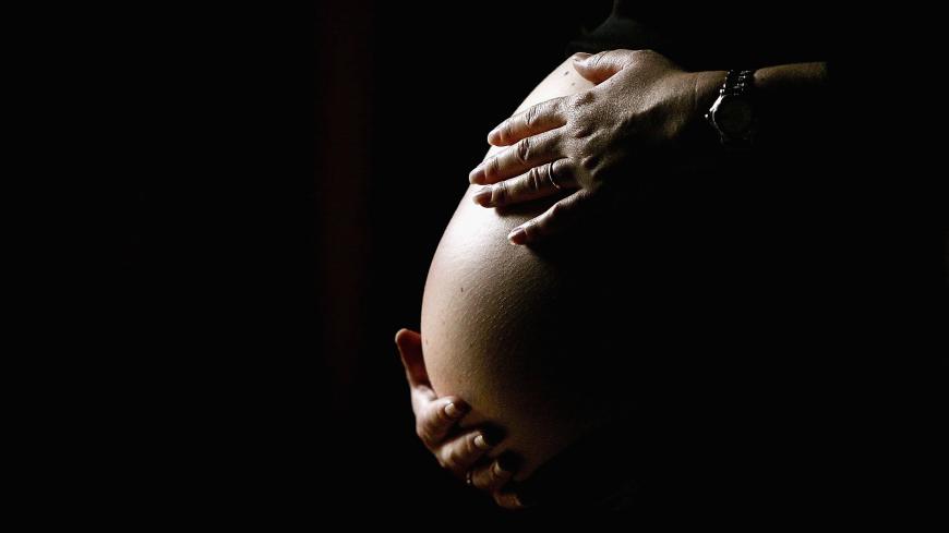 SYDNEY, NSW - JUNE 07: A pregnant woman holds her stomach June 7, 2006 in Sydney, Australia. Australia is currently enjoying a baby boom, with the Australian Bureau of Statistics registering a 2.4% increase in births from 2004 to 2005, which represents the highest number of births since 1992. The Australian Federal Government has been encouraging people to have more babies, with financial incentives and the slogan by treasurer Peter Costello to "have one for mum, one for dad, and one for the country". The