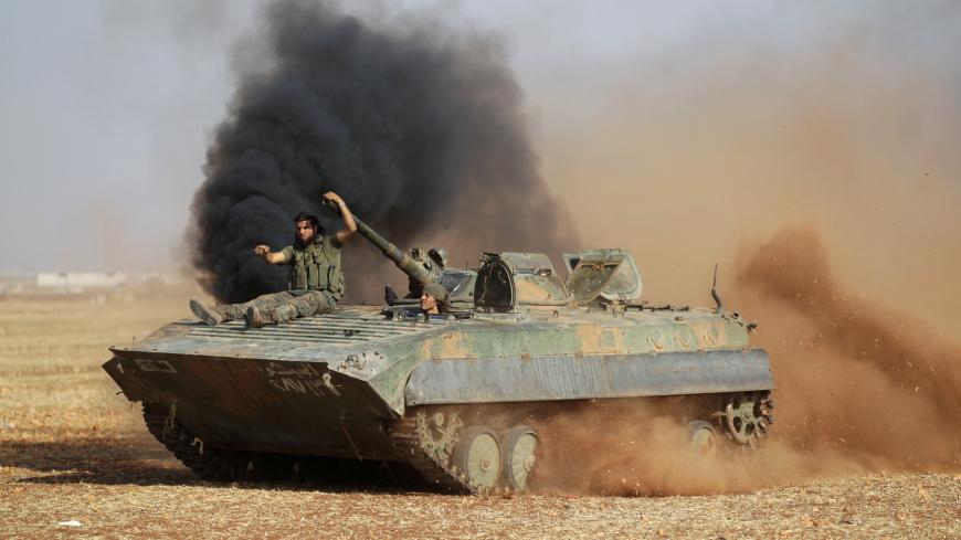 Rebel fighters ride a military vehicle on the outskirts of Syria Democratic Forces (SDF) controlled Tell Rifaat town, northern Aleppo province, Syria October 22, 2016. Picture taken October 22, 2016. REUTERS/Khalil Ashawi - S1AEUIPWQCAB