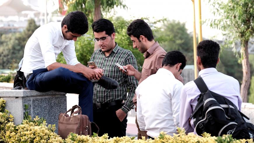 Iranian youth use their mobile phones as they rest at a park in Tehran, Iran, May 16, 2017. REUTERS/TIMA ATTENTION EDITORS - THIS IMAGE WAS PROVIDED BY A THIRD PARTY. FOR EDITORIAL USE ONLY. - RC1A55C54480
