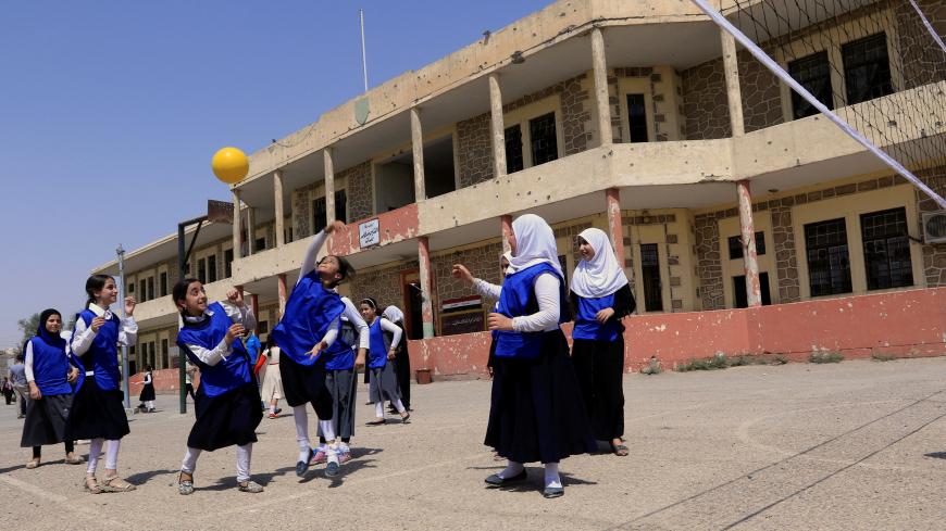 Iraqi girls play in a yard of a school in Mosul, Iraq July 18, 2017. REUTERS/Ari Jalal - RC1CE6912440