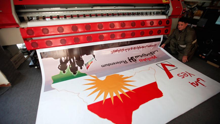A man looks at a printed banner of Kurdistan region referendum in Erbil, Iraq August 26, 2017. Picture taken August 26, 2017. REUTERS/Azad Lashkari - RC1D90FE8B20