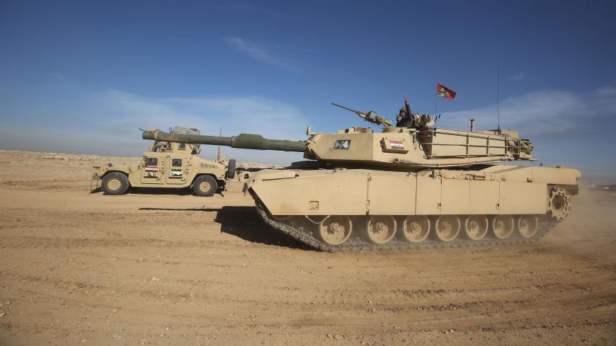 Iraqi forces, supported by the Hashed al-Shaabi (Popular Mobilisation) paramilitaries, advance near the village of Husseinyah, south of Mosul on February 20, 2017, during the offensive to retake the western side of Mosul. / AFP / AHMAD AL-RUBAYE (Photo credit should read AHMAD AL-RUBAYE/AFP/Getty Images)