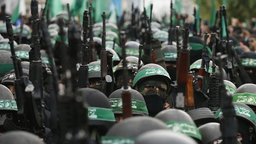 Palestinian members of al-Qassam Brigades, the armed wing of the Hamas movement, take part in a military parade marking the 27th anniversary of Hamas' founding, in Gaza City December 14, 2014. REUTERS/Mohammed Salem (GAZA - Tags: POLITICS MILITARY ANNIVERSARY) - GM1EACE1NB801