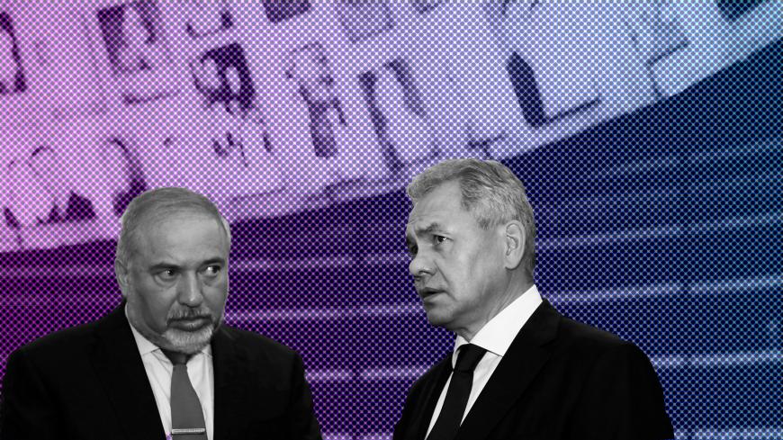 Russian Defence Minister Sergey Shoigu (R) stands next to his Israeli counterpart Avigdor Lieberman as as they look at pictures of Jews killed in the Holocaust during a visit to the Hall of Names at Yad Vashem's Holocaust History Museum in Jerusalem October 17, 2017. REUTERS/Ronen Zvulun - RC1504C794D0