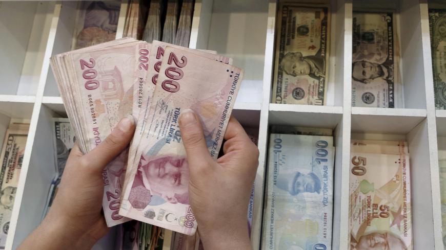 A money changer counts Turkish lira bills at an currency exchange office in central Istanbul, Turkey, August 21, 2015. REUTERS/Murad Sezer/File Photo - S1BETTHGKMAB
