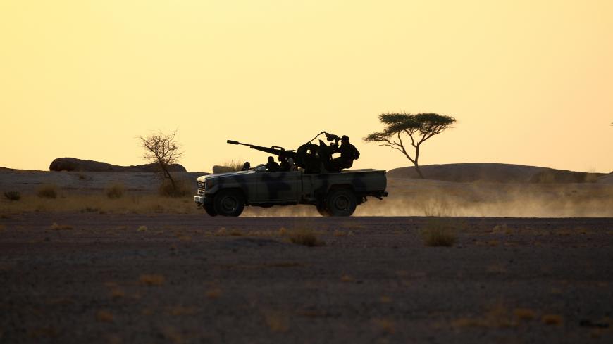 The Polisario Front soldiers drive a pick-up truck mounted with an anti-aircraft weapon during sunset in Bir Lahlou, Western Sahara, September 9, 2016. REUTERS/Zohra Bensemra SEARCH ìPOLISARIOî FOR THIS STORY. SEARCH "WIDER IMAGE" FOR ALL STORIES. - S1BEUKRIISAA