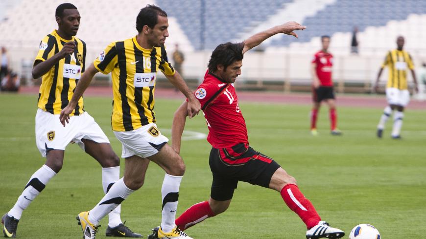EDITORS' NOTE: Reuters and other foreign media are subject to Iranian restrictions on leaving the office to report, film or take pictures in Tehran.

Hossein Badamaki (R) of Iran's Persepolis, Mishal Al Saeed (C) and Saud Khariri of Saudi Arabia's Al-Ittihad fight for the ball during their AFC Champions League soccer match at Tehran's Azadi stadium May 3, 2011. REUTERS/Raheb Homavandi (IRAN - Tags: SPORT SOCCER) - GM1E75400KD01