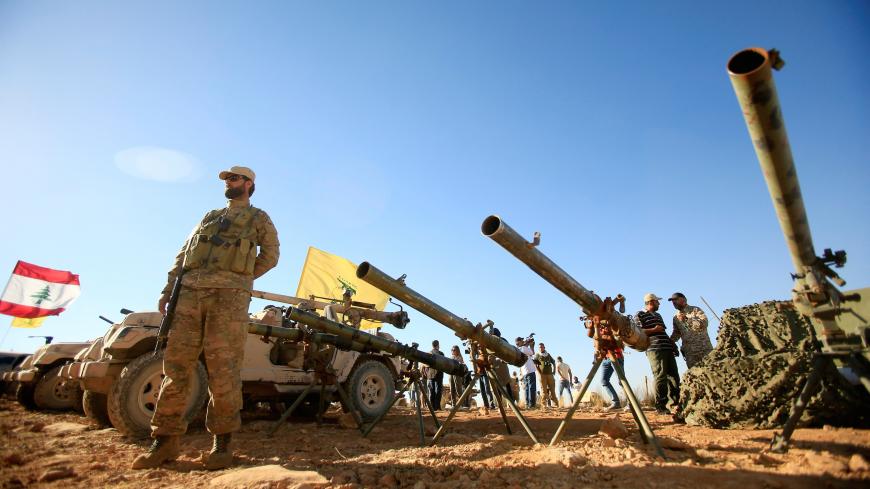 A Hezbollah fighter stands in front of anti-tank artillery at Juroud Arsal, the Syria-Lebanon border, July 29, 2017. REUTERS/Ali Hashisho     TPX IMAGES OF THE DAY - RC1B7DA4AC10