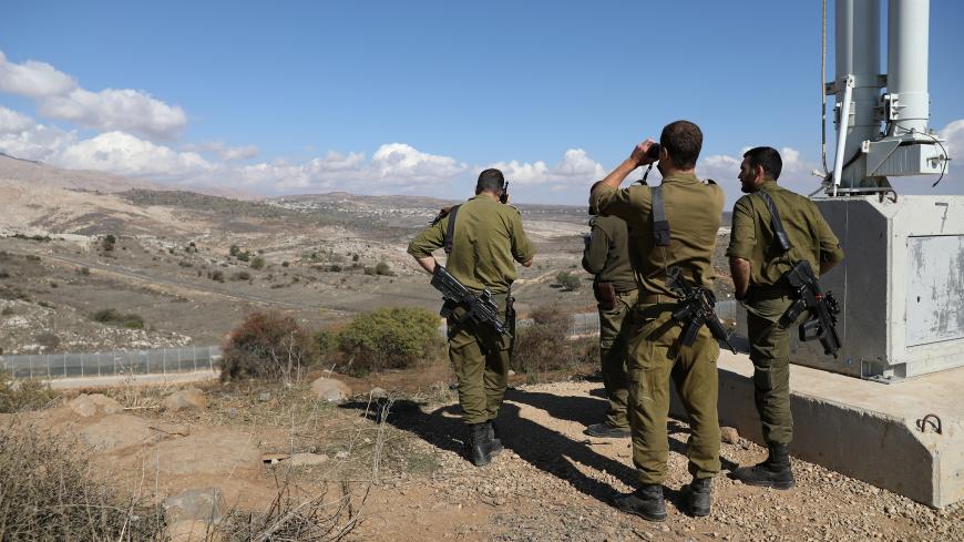 Israeli forces are seen near a border fence between the Israeli-occupied side of the Golan Heights and Syria, November 4, 2017. REUTERS/Ammar Awad - RC19166D7D10