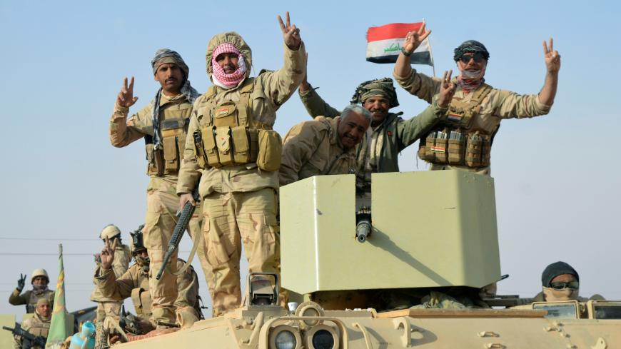 Iraqi forces show victory signs after they captured Rawa town, the last remaining town under Islamic State control, Iraq November 17, 2017. REUTERS/Stringer - RC16EFE59700