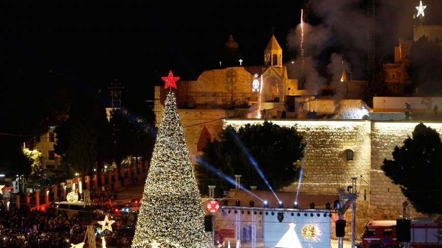 Fireworks explode during a Christmas tree lighting ceremony outside the Church of the Nativity in the West Bank town of Bethlehem December 3, 2016. REUTERS/Mussa Qawasma - RC1514D50930
