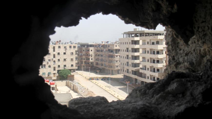 A general view shows a deserted street at the beginning of the Yarmouk Palestinian refugee camp April 29, 2015. A bout of fighting between militants over control of the Yarmouk refugee camp on the edge of Damascus has only compounded the misery of residents already suffering from acute shortages of food, clean water and power. REUTERS/Ward Al-Keswani - GF10000077547