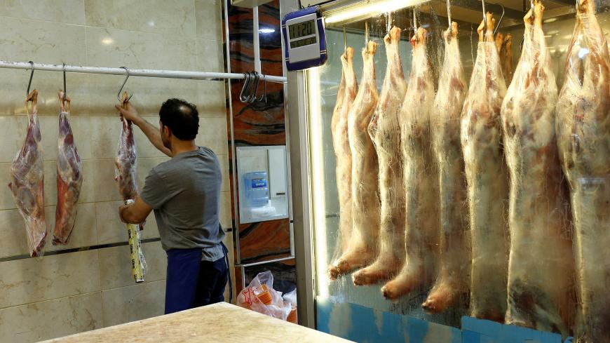 A butcher holds pieces of beef at a meat shop in Istanbul, Turkey, July 27, 2017. REUTERS/Murad Sezer - RC11950E5810