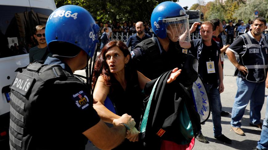 Lawyer Ruken Arslan detained by riot police during the trial of two Turkish teachers, who went on a hunger strike over their dismissal under a government decree following last year's failed coup, outside of a courthouse in Ankara, Turkey September 14, 2017. REUTERS/Umit Bektas - RC11F5408250