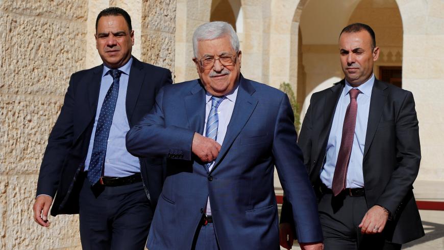 Palestinian President Mahmoud Abbas walks to speaks to the media after his meeting with Jordan's King Abdullah  at the Royal Palace in Amman, Jordan October 22, 2017. REUTERS/Muhammad Hamed - RC1526556A90