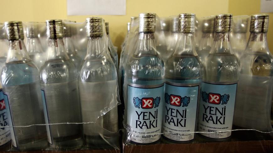 Yellow capped new bottles of Turkish liquor of "Yeni Raki" remain packed at a alcohol sales spot in Istanbul March 9, 2005. A Turkish alcohol company on Tuesday ordered the recall of millions of bottles of Turkish liquor as the death toll from a bootleg version of the drink rose to at least 22.[ Galip Yorgancioglu, chief executive of Mey Drinks, said the firm was recalling all 0.7-litre bottles of Tekel brand raki, a popular anise-flavoured drink. Other sizes and brands would remain on shelves. ] - PBEAHUOC