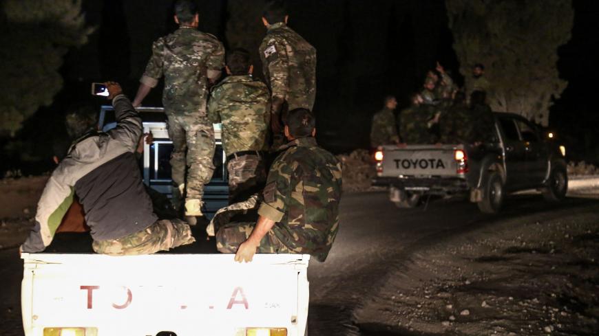 Pro-Ankara Syrian rebel fighters are seen riding on pickup trucks near the village of Hawar Killis along the Syrian-Turkish border in the northern province of Aleppo on October 6, 2017, as they advance towards jihadist-controlled Idlib province.
Turkish President Recep Tayyip Erdogan said in a televised speech on October 7 that the pro-Ankara Syrian rebels were "taking new steps to ensure security in Idlib".
Erdogan later told reporters the operation was led by "Free Syrian Army" (FSA) rebels and that the T